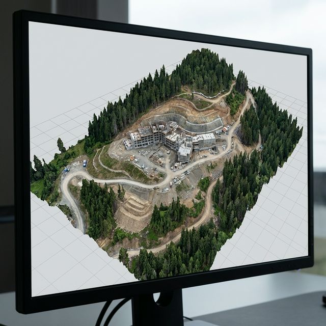 3D photogrammetry model of mountain construction site showing textured mesh reconstruction