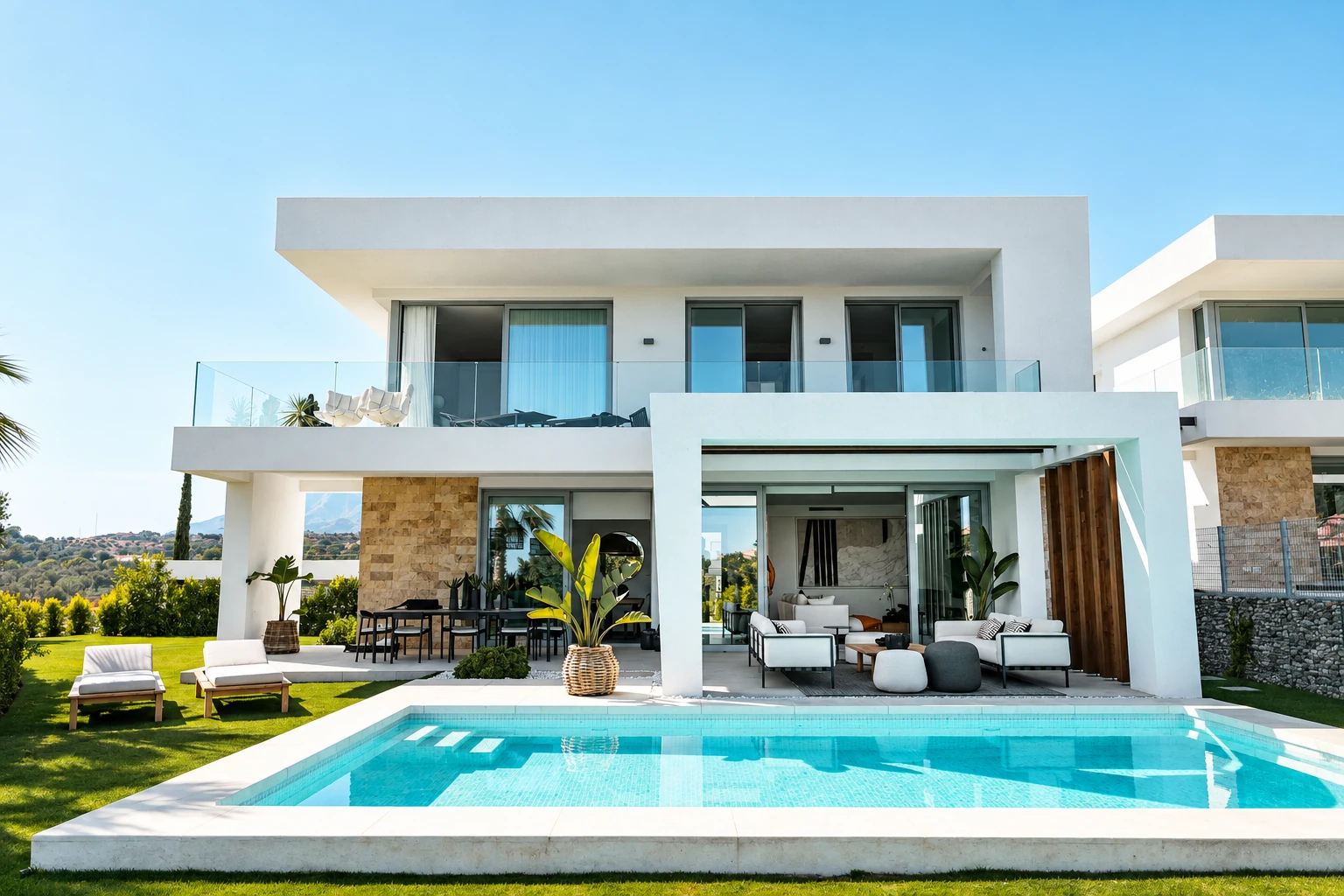 A white villa with a pool, photographed for a property listing